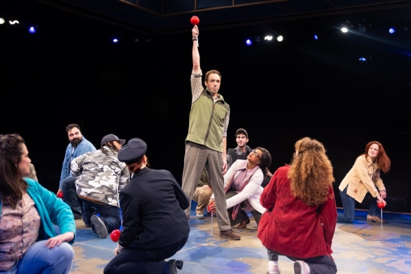 Alex Goodrich (center) and cast in Come From Away at Marriott Theatre.